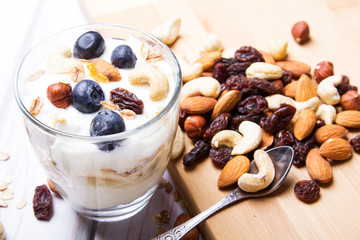 Healthy dessert with yogurt, nuts, oats and blueberries