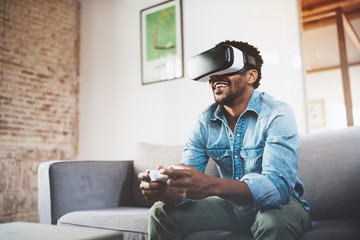 Concept of technology,gaming,entertainment and people.Happy african man enjoying virtual reality...