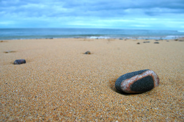 Fototapeta na wymiar Close up of a banded pebble on beach.