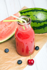 Fresh watermelon juice on a wooden background