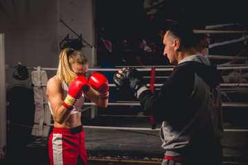 Girl Training on mitts with her boxing instructor
