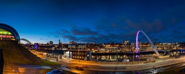 Newcastle Quayside Panorama at night, on the banks of the River Tyne, with its famous bridges and...