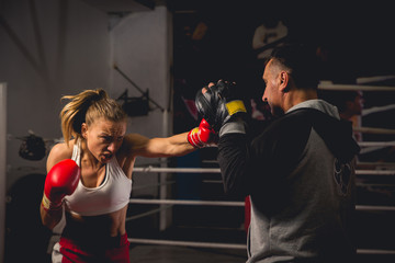 Girl Training on mitts with her boxing instructor
