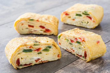 Traditional tamagoyaki Japanese omelette on wooden background