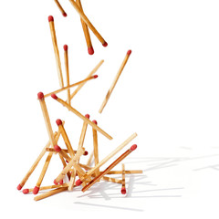 Matches with red tips are falling on white background