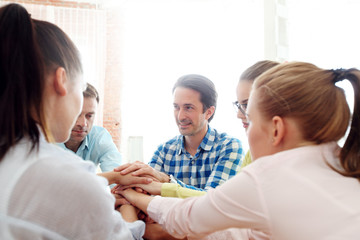 Obraz premium Coworkers stacking hands