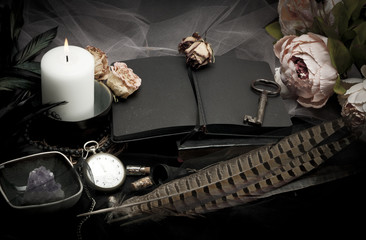Vintage table with paper, flowers, old watch and candle