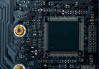 Fototapeta premium Integrated semiconductor microchip microprocessor on blue circuit board representative of the high tech industry and computer science.macro.concept compute harware