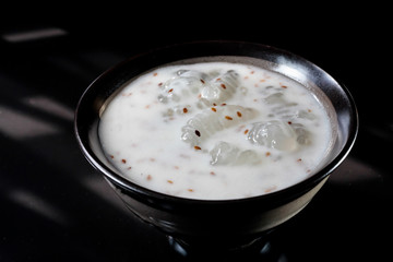 Caramelized crisps in coconut sauce. Thai dessert.