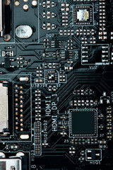 Fototapeta premium Integrated semiconductor microchip microprocessor on blue circuit board representative of the high tech industry and computer science.macro.concept compute harware