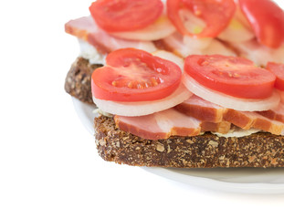 Sandwich with ham, tomato, onion and lettuce.