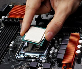 Plug in CPU microprocessor to motherboard socket. Technological background.Concept computers harware