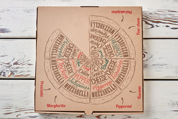 Pizza box on wooden background.