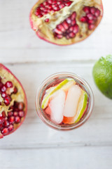 Top view of pomegranate lemonade with lime and ice
