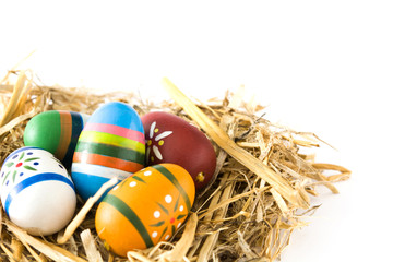 Easter eggs in a nest isolated on white background.Copyspace
