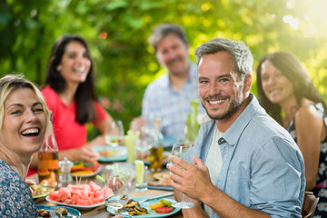  a group of friends gathered around a table on a terrace