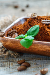 Bowl with ground coffee and mint closeup.