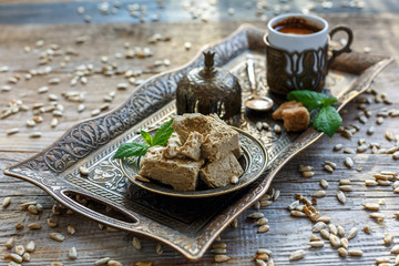 Halva on a tray and a cup of black coffee.