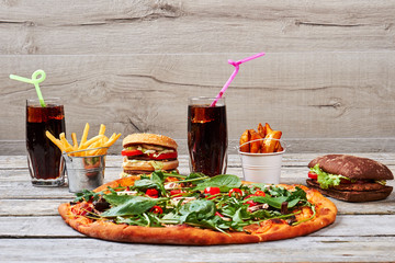 Junk food on wooden background.