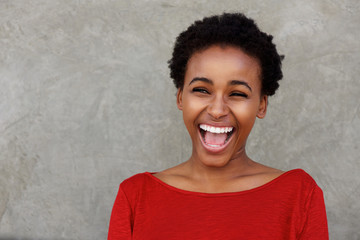 beautiful young black woman laughing with open mouth
