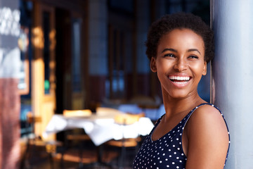 smiling young black woman standing outside