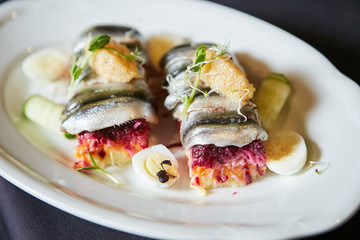 Salad of vegetables and fish herring for snack