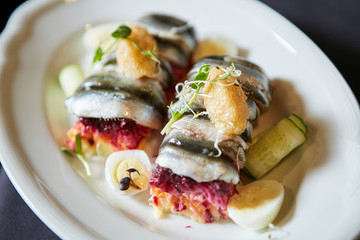 Salad of vegetables and fish herring for snack