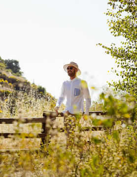 Man Walking In Countryside On Summer Day