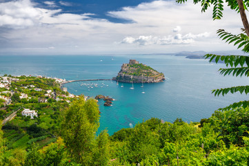 Aerial scenic view on Aragonese castle through foliage, Ischia, Italy
