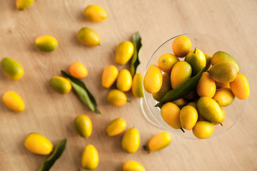 Fototapeta na wymiar Lots of vitamins in one delicious asian fruit kumquat. Healthy food for vegetarian.