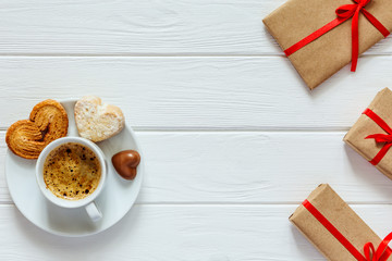 Valentines Day Concept wrapped Gifts Coffee with Candies on Wood