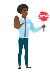 Caucasian businessman holding stop road sign.