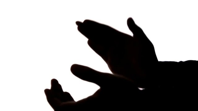 dark silhouette of male hands clapping, applause