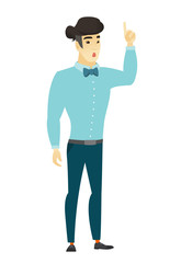 Businessman with open mouth pointing finger up.