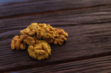 Walnut on the wooden table dark textural
