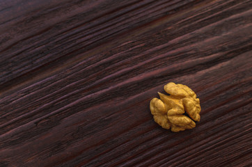 Walnut on the wooden table dark textural
