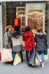 Happy female group of friends doing shopping together