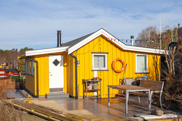 Yellow wooden cabin on the island, Norwegian style