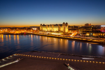Evening view of the house on the city's waterfront, illuminated by night lights in Oslo, Norway.