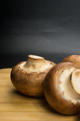 mushroom champignons on a wooden Board