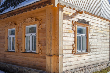 Fototapeta na wymiar New wooden house wall in traditional carving style