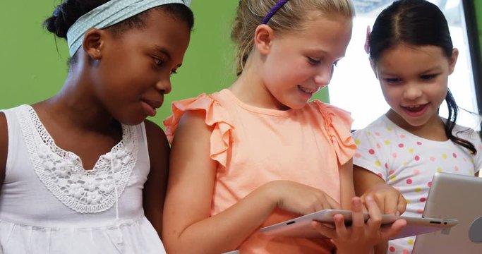 Slow motion of schoolgirls using digital tablet at school 4k