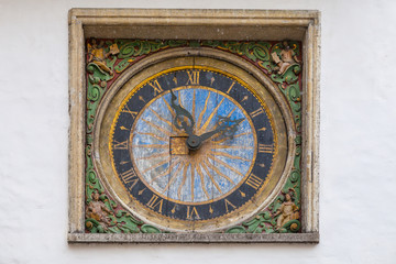 Fototapeta na wymiar Historical medieval gothyc style clock of church in old european town