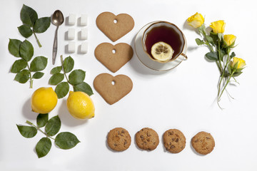 Ornament of lemons, cookies and rose leaves on white background. Recipe of gingerbread
