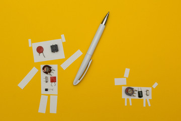 Robot paper holding a pen near the dog