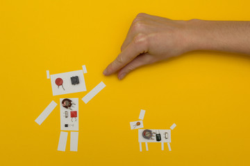 Small paper robot holding a man's hand