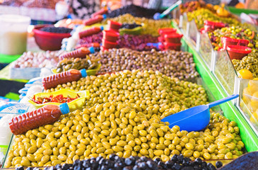 Market stall selling fresh olives.