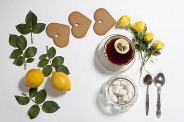 Ornament of lemons, cookies and rose leaves on white background. Recipe of gingerbread