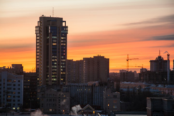 Fototapeta na wymiar Modern buildings of Voronezh on background of crimson sunset 