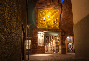 Night view of street with Golden relief of a knight with sword
